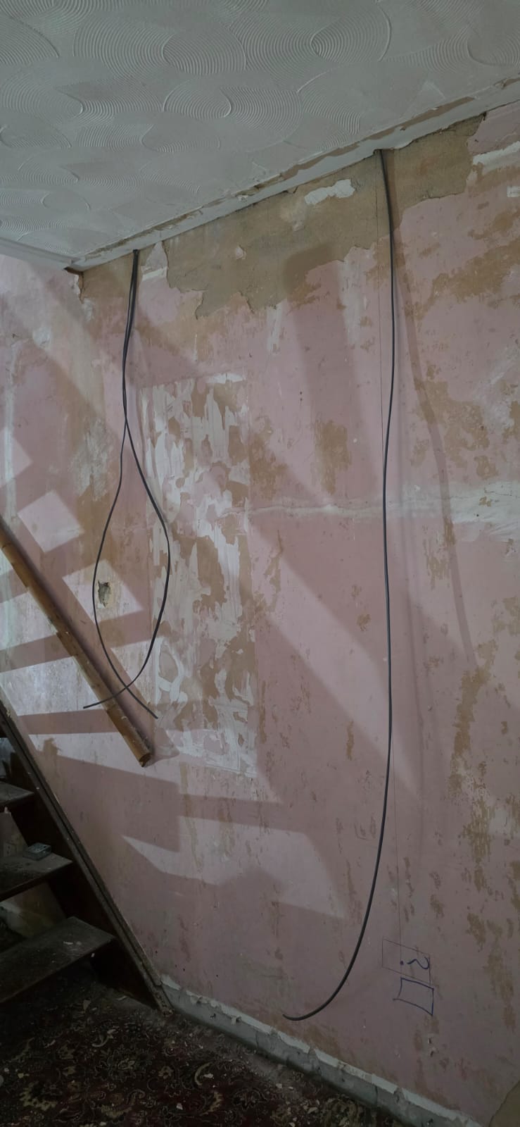 Stripped walls exposing old wiring during a house rewire in Cardiff