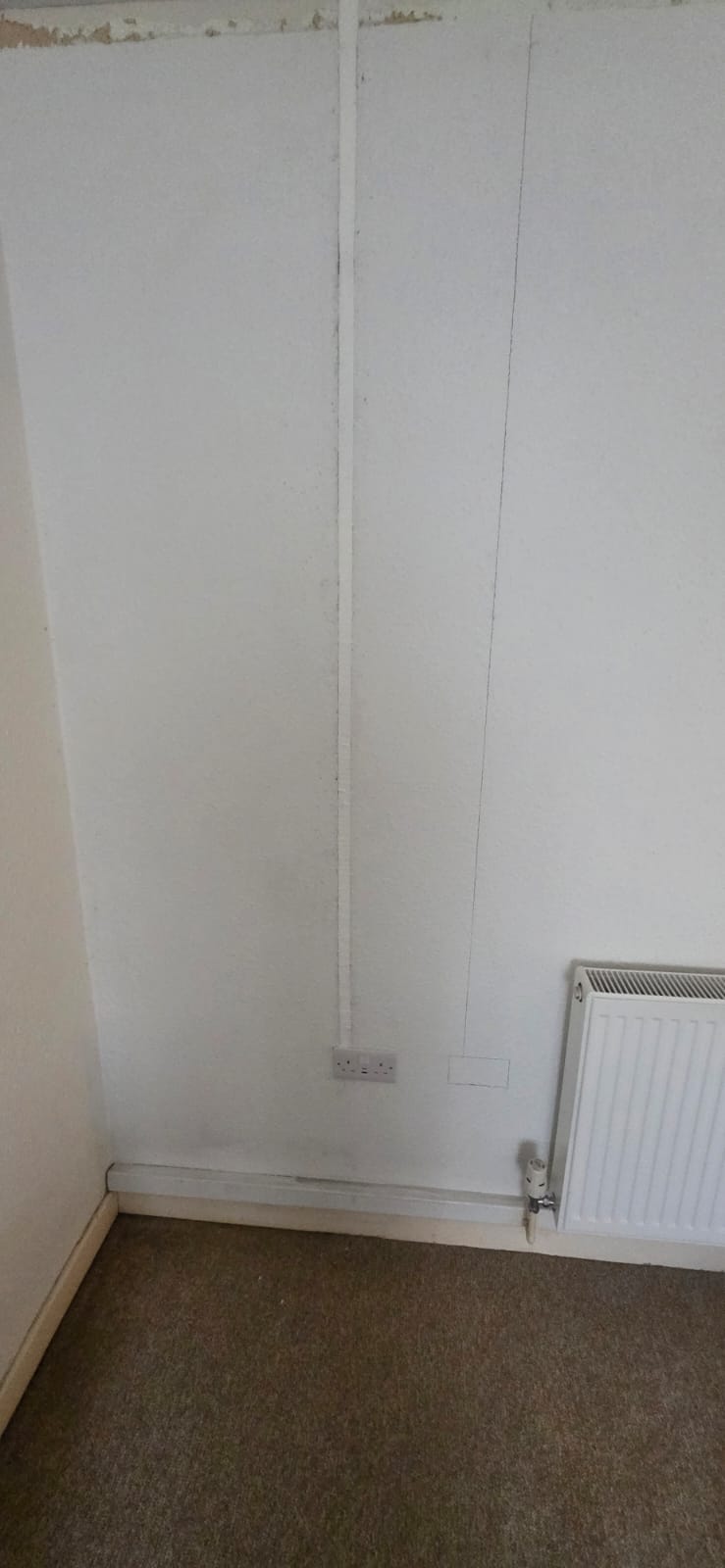Socket chase cut into wall for partial rewire in Cardiff